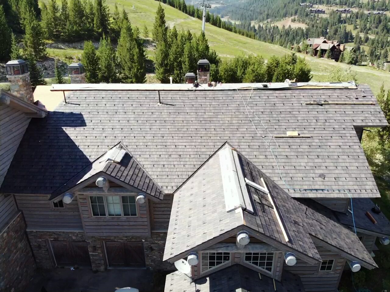 Aerial view of a cedar shake mountain estate roof in Big Sky