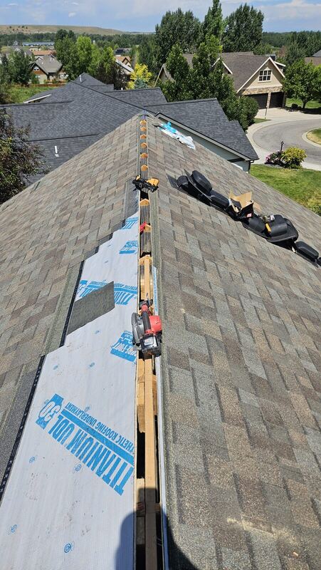 Shingle re-roof with mountain backdrop — Montana