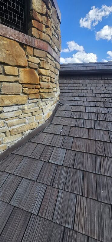 Cedar shake with soldered copper valley & stone chimney — Montana
