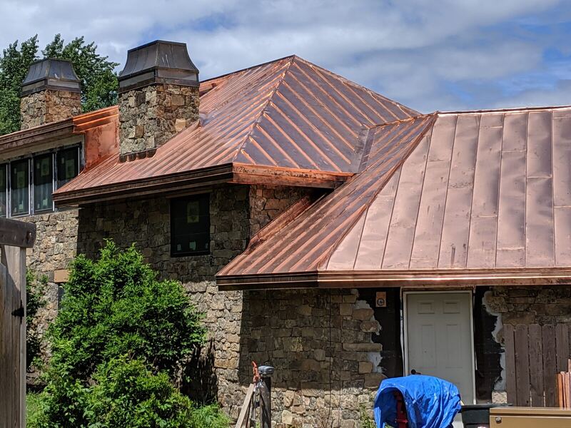 Copper roof with matching chimney caps — Montana