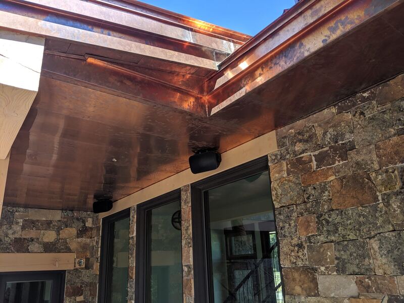 Copper soffit and fascia running over natural stone